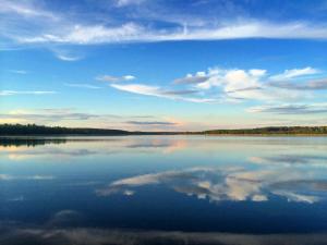 a large body of water with a blue sky and clouds at Guest house Ura Seliger in Sloboda