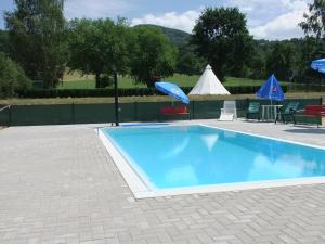 a swimming pool with a table and chairs and a tent at Hotel Formule in Děčín