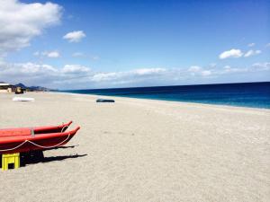 a beach with two boats sitting on the sand at Le Ville della Contea -Vacation rentals in Mascali +92 photos