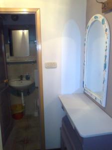 a bathroom with a sink and a mirror at Apartment Anetica in Cres