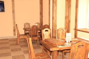 
a wooden table and chairs in a room at Hotel Complex Rus in Kaluga
