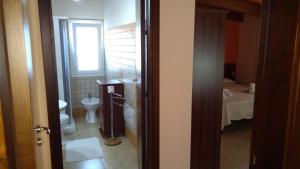 a small bathroom with a toilet and a sink at Villa Margherita in Sciacca