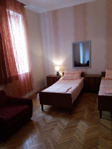 Postel nebo postele na pokoji v ubytování Guest House Lviv Грузия