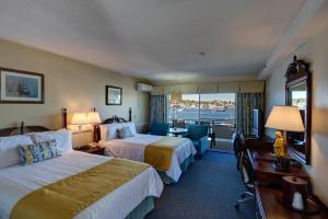 a hotel room with two beds and a window at Browns Wharf Inn in Boothbay Harbor