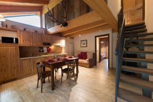a kitchen and dining room with a table and chairs at La Maison De Toyen in Nus
