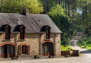 a stone house with a pathway leading up to it at Gite de la Croix du Hêtre in Hambers