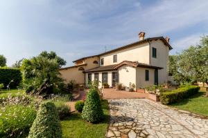 an exterior view of a house with a garden at Villa Pallina with Pool - Happy Rentals in Massarosa