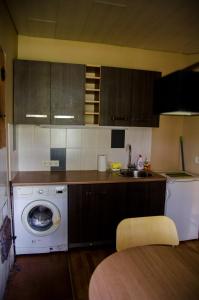a kitchen with a washing machine and a dishwasher at Posti 19 Apartment in Haapsalu +6 photos