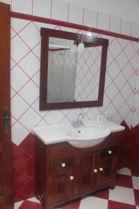 a bathroom with a sink and a mirror at La Casa del Abuelo in Los Sauces +23 photos