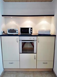 a kitchen with a microwave and a toaster oven at Ferienwohnung Am Ueckerpark in Ueckermünde