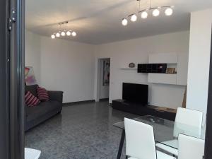 a living room with a couch and a table at Central Seaview Apartment Puerto del Carmen in Puerto del Carmen