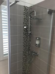 a shower with a glass door in a bathroom at Pula Antic Rooms in Center in Pula