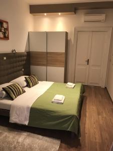 a bedroom with a bed with two towels on it at Pula Antic Rooms in Center in Pula