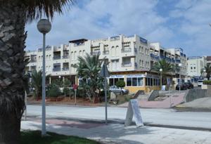 a building on a street with a sign in front of it at Azucena in Garrucha