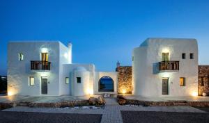 a large white house with lights on it at night at Axiotheaton Villas in Pefki Rhodes