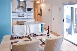 a kitchen with a table with chairs and a dining room at Beachfront apartment in paradise in San Andrés