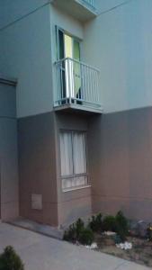 a building with a balcony on the side of it at Apartamento mobiliado in Feira de Santana