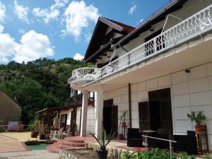 a building with a balcony on top of it at Valcsics Villa Panzió in Pécs +5 photos