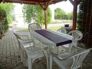 a white table and chairs on a patio at Albízia Apartments in Balatonfüred
