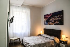 a bedroom with a bed and a large window at B&B Caracciolo 109 in Naples