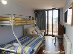 a bedroom with a bunk bed and a balcony at Rural Colldejou Cal Caterí in Colldejou