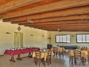 a large room with tables and chairs and a pool table at Gelsomino B&B in Ispica