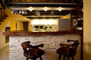 a bar with two chairs and a stone wall at Starburst Bed & Breakfast宜蘭羅東星賞民宿 in Dongshan