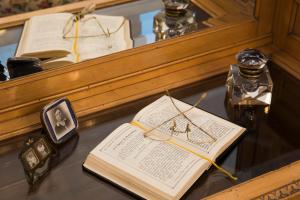 an open book sitting on a table next to a mirror at Residenza Fabroni in Montepulciano