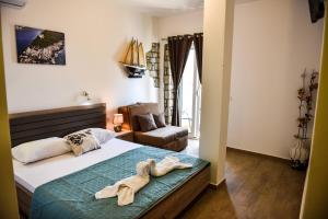 a bedroom with a bed with towels on it at Villa Dulcinea in Ulcinj