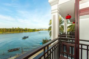 a balcony of a house with a view of the water at Pearl River Hoi An Hotel & Spa in Hoi An