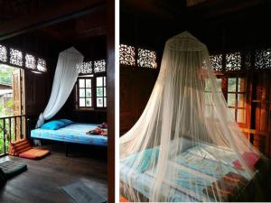 a bedroom with a bed with a mosquito net at Chatawan Homestay in Phrae