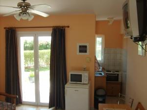 a kitchen with a microwave on top of a refrigerator at Gouna's Aparts in Xi +19 photos