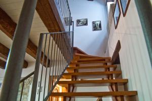 a spiral staircase in a house with wooden ceilings at Bed And Breakfast Pa' Carrera in Fragneto Monforte