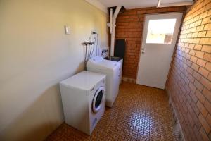 a white toilet sitting next to a white wall at City Centre Apartments in Grafton