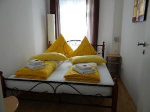 a bedroom with a bed with yellow pillows and a window at Apartments City Room Berlin in Berlin