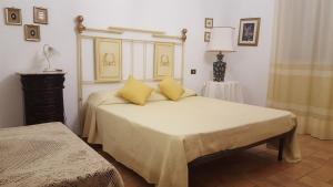 a bedroom with a large bed with yellow pillows at La Guardata in Montefiascone +27 photos