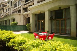 a table and chairs in front of a building at Hermitage Suites Koregaon Park Garden & Terrace Room in Pune