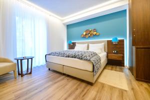 Ένα ή περισσότερα κρεβάτια σε δωμάτιο στο Boutiquehotel Wörthersee - Serviced Apartments