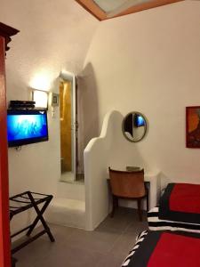 A television and/or entertainment centre at Timedrops Santorini Villas