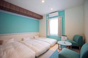 Postel nebo postele na pokoji v ubytování La'gent Hotel Tokyo Bay