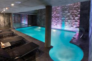 a pool in a building with a lit up wall at Endless Art Hotel-Special Category in Istanbul