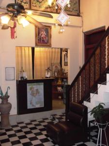 a living room with a staircase and a checkered floor at Rim Ping Guest House in Chiang Mai