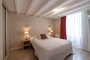 a bedroom with a bed and a large window at La Pommeraie in Bruz