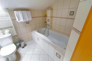 a bathroom with a bath tub and a toilet at Apartmán Relax in Smižany