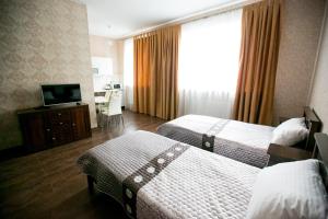เตียงในห้องที่ Apart-hotel Kaut Kompanya