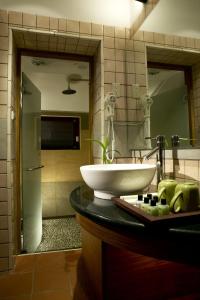 a bathroom with a sink and a tub at Taroko Village Hotel in Fushi