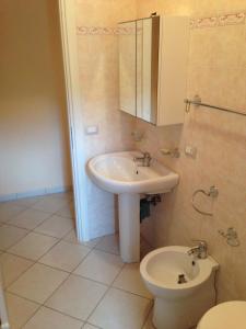 een badkamer met een wastafel en een toilet bij Casa degli Agrumi in Capo dʼOrlando