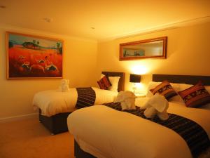 a hotel room with two beds with stuffed animals on them at Thai Season in York