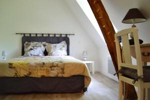 a bedroom with a bed with a teddy bear on it at La Cle de Saule in Saint-Maclou-de-Folleville