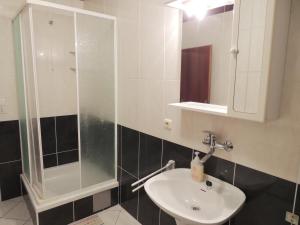 a bathroom with a sink and a shower at Apartments Jelena in Pag